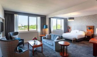 Spacious king suite with living room and working station at the Hilton Strasbourg.