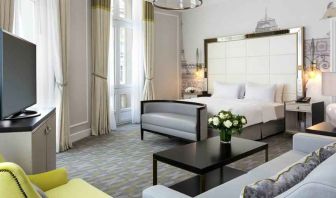 Spacious hotel suite with sofa and TV screen at the Hilton Paris Opera.