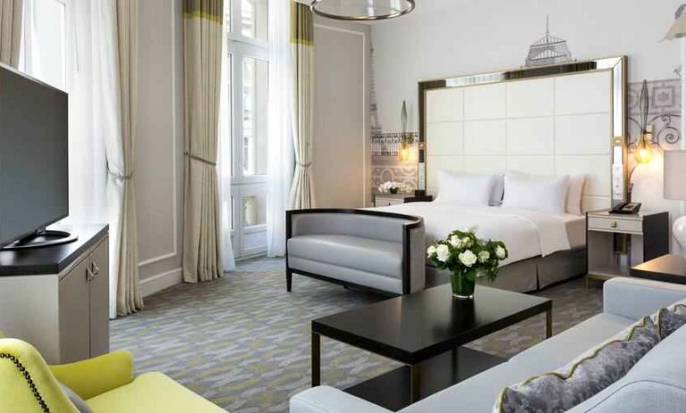 Spacious hotel suite with sofa and TV screen at the Hilton Paris Opera.