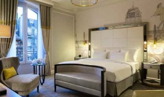 Bright queen room with window at the Hilton Paris Opera.