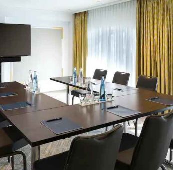 Meeting room with small u shape table at the Hilton Paris Opera.