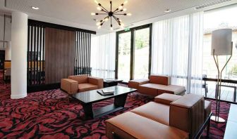 Lobby workspace with sofas at the Hampton by Hilton Toulouse Airport.