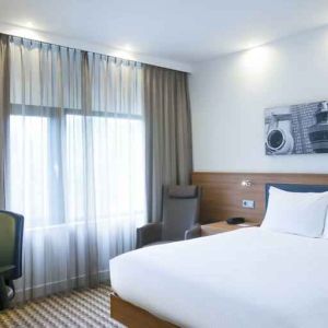 King bedroom with desk at the Hampton by Hilton Amsterdam Airport Schiphol.