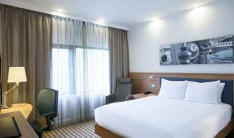 King bedroom with desk at the Hampton by Hilton Amsterdam Airport Schiphol.