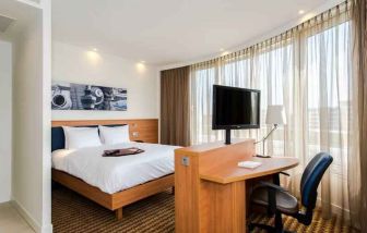 King suite with working station at the Hampton by Hilton Amsterdam Airport Schiphol.