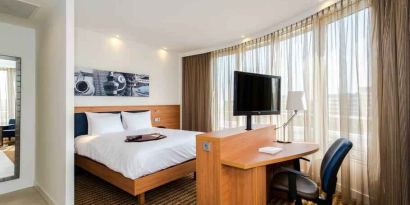 King suite with working station at the Hampton by Hilton Amsterdam Airport Schiphol.