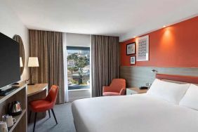 luxurious king suite with TV and work space at Hampton by Hilton Torquay.