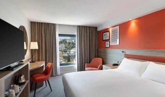 luxurious king suite with TV and work space at Hampton by Hilton Torquay.