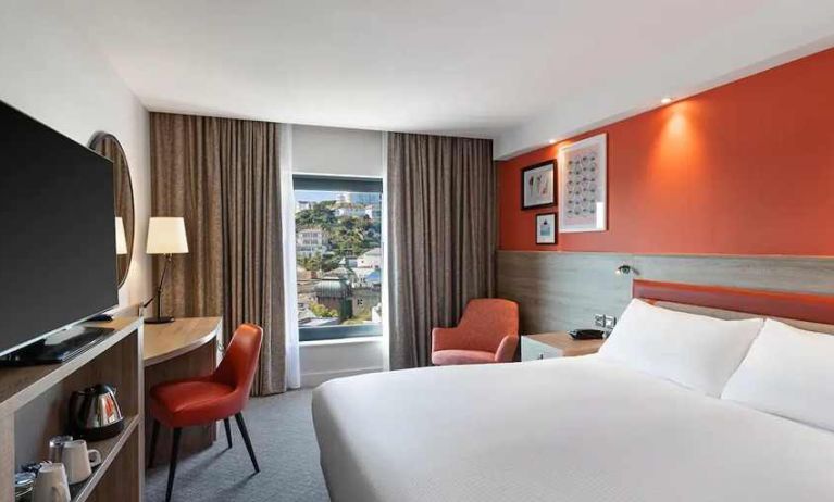 luxurious king suite with TV and work space at Hampton by Hilton Torquay.