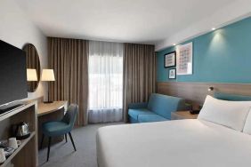 spacious king room with work and lounge area at Hampton by Hilton Torquay.