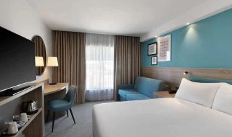 spacious king room with work and lounge area at Hampton by Hilton Torquay.