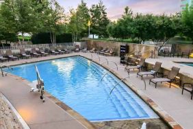 Relaxing outdoor pool at the Hilton Dallas Plano Granite Park.