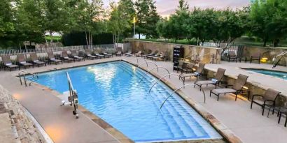 Relaxing outdoor pool at the Hilton Dallas Plano Granite Park.