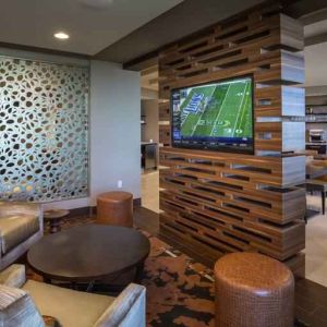 Lobby workspace with TV screen at the Hilton Dallas Plano Granite Park.