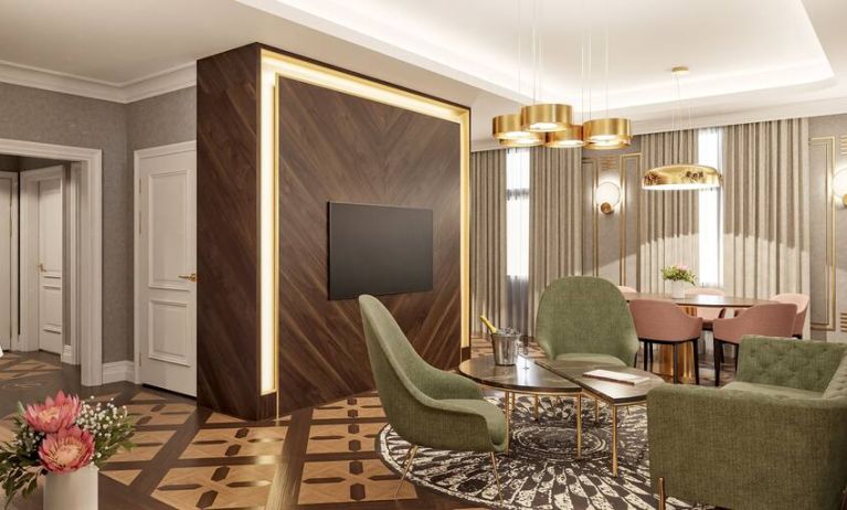 Living room with table, chairs and sofa at the Hotel Saski Krakow Curio Collection by Hilton.