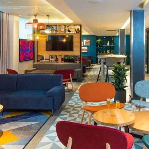 spacious and well lit lounge and coworking space at Hampton by Hilton London Park Royal.