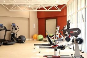 well equipped fitness center with lots of natural light at DoubleTree by Hilton Bristol City Centre.