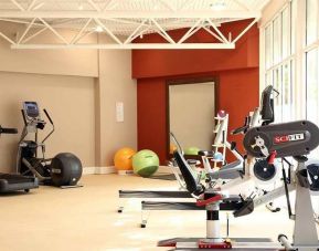 well equipped fitness center with lots of natural light at DoubleTree by Hilton Bristol City Centre.