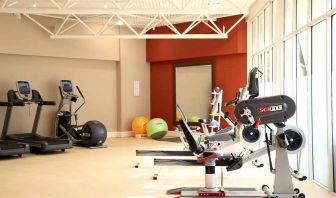 well equipped fitness center with lots of natural light at DoubleTree by Hilton Bristol City Centre.