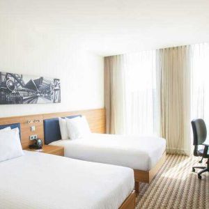 Twin room with working station at the Hampton by Hilton Amsterdam Arena Boulevard.