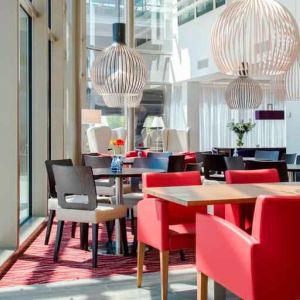 Hotel workspace with chairs and tables at the Hampton by Hilton Amsterdam Arena Boulevard.