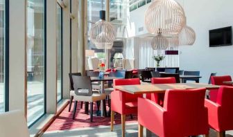 Hotel workspace with chairs and tables at the Hampton by Hilton Amsterdam Arena Boulevard.