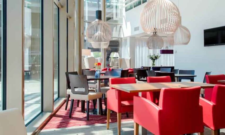 Hotel workspace with chairs and tables at the Hampton by Hilton Amsterdam Arena Boulevard.