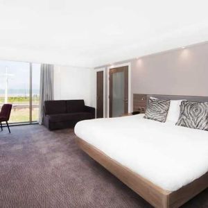 spacious king suite with lounge and work area and lots of natural light ideal for working remotely at Hampton by Hilton Blackpool.