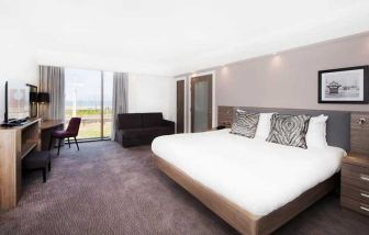 spacious king suite with lounge and work area and lots of natural light ideal for working remotely at Hampton by Hilton Blackpool.