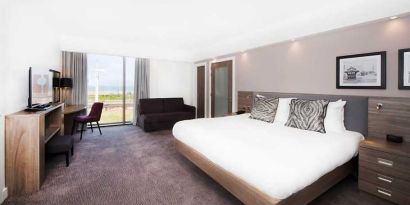 spacious king suite with lounge and work area and lots of natural light ideal for working remotely at Hampton by Hilton Blackpool.