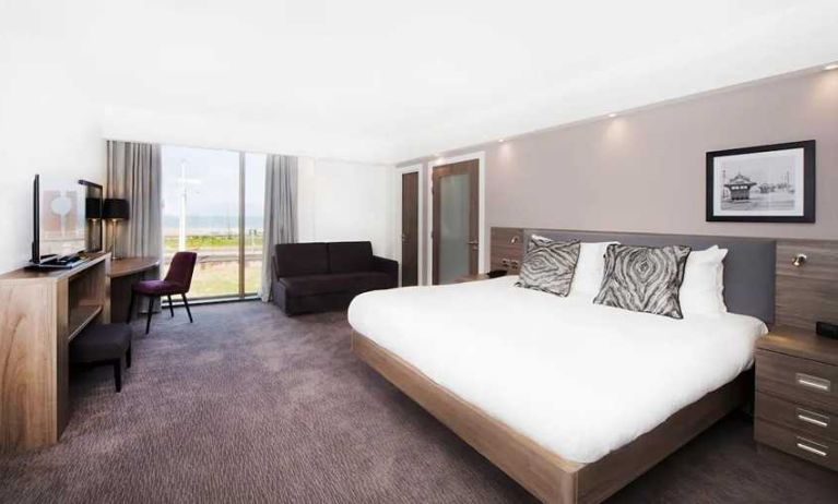 spacious king suite with lounge and work area and lots of natural light ideal for working remotely at Hampton by Hilton Blackpool.