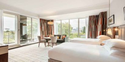 Twin room with large windows and desk at the Hilton Amsterdam.