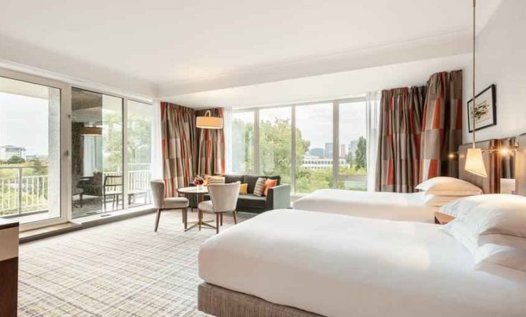 Twin room with large windows and desk at the Hilton Amsterdam.