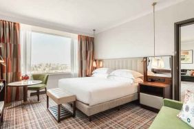 Comfortable king suite with working station at the Hilton Amsterdam.