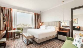 Comfortable king suite with working station at the Hilton Amsterdam.