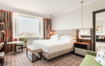 Comfortable king suite with working station at the Hilton Amsterdam.