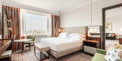 Comfortable king suite with working station at the Hilton Amsterdam.