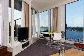 Bright living room overlooking the canals at the DoubleTree by Hilton Amsterdam Centraal Station.