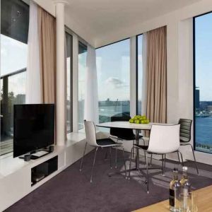 Bright living room overlooking the canals at the DoubleTree by Hilton Amsterdam Centraal Station.