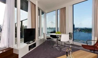 Bright living room overlooking the canals at the DoubleTree by Hilton Amsterdam Centraal Station.