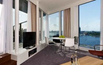 Bright living room overlooking the canals at the DoubleTree by Hilton Amsterdam Centraal Station.