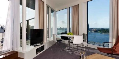 Bright living room overlooking the canals at the DoubleTree by Hilton Amsterdam Centraal Station.