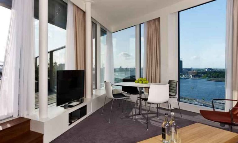 Bright living room overlooking the canals at the DoubleTree by Hilton Amsterdam Centraal Station.