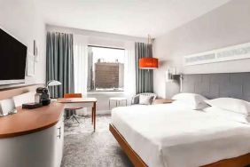 King bedroom with desk and TV screen at the Hilton Rotterdam.