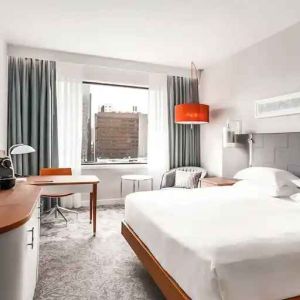 King bedroom with desk and TV screen at the Hilton Rotterdam.