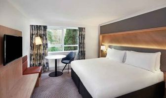 spacious king room with TV, comfortable work desk and natural light at Hilton Cobham.