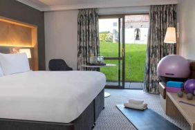 lovely king room with yoga and strateching equipment and garden view at Hilton Cobham.