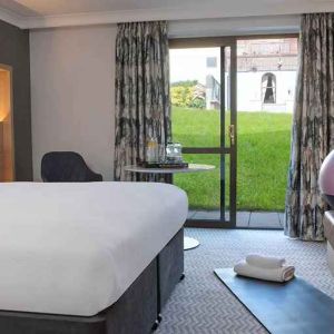 lovely king room with yoga and strateching equipment and garden view at Hilton Cobham.