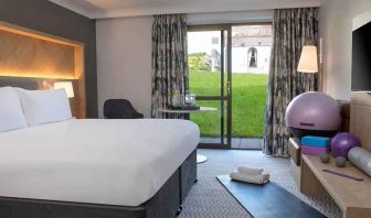 lovely king room with yoga and strateching equipment and garden view at Hilton Cobham.