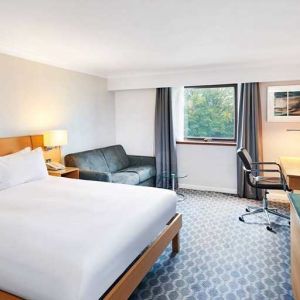 Spacious king room with TV, comfortable work desk and natural light at Hilton London Watford.